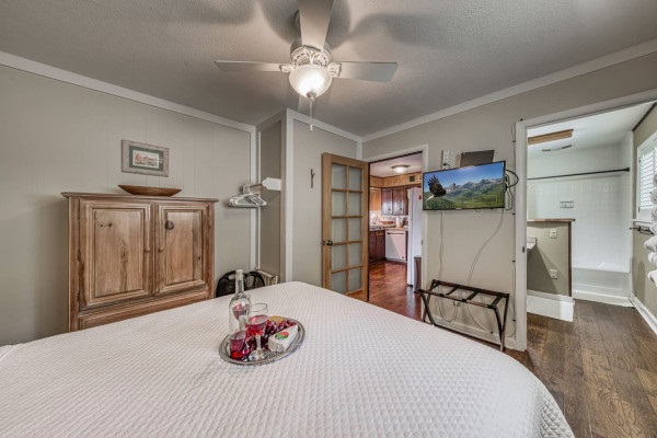 Rest easy in this cozy bedroom featuring a plush queen-sized bed and a TV for your ultimate comfort and relaxation!