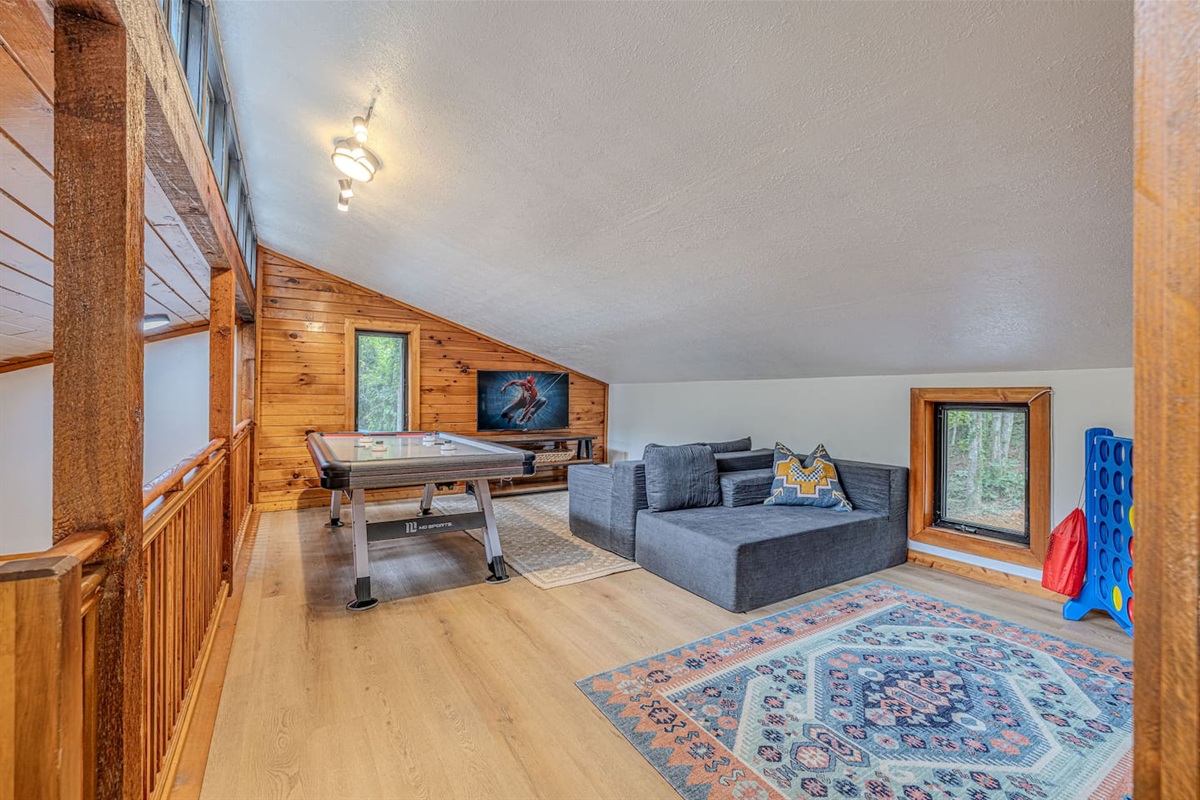 The upstairs game loft delivers even more entertainment with air hockey, life-sized Connect 4, a Smart TV, and comfortable modular seating.