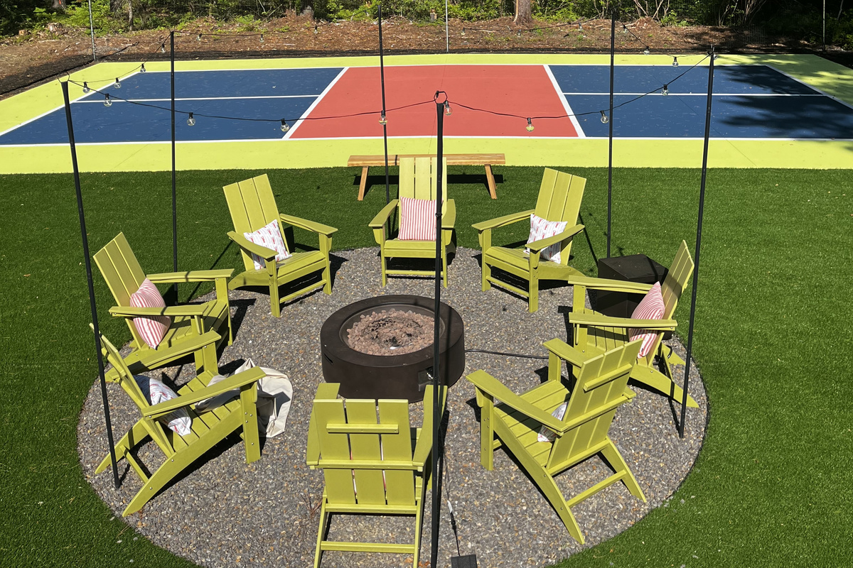 Our pickleball court and firepit, where energy meets warmth, and good times come together!