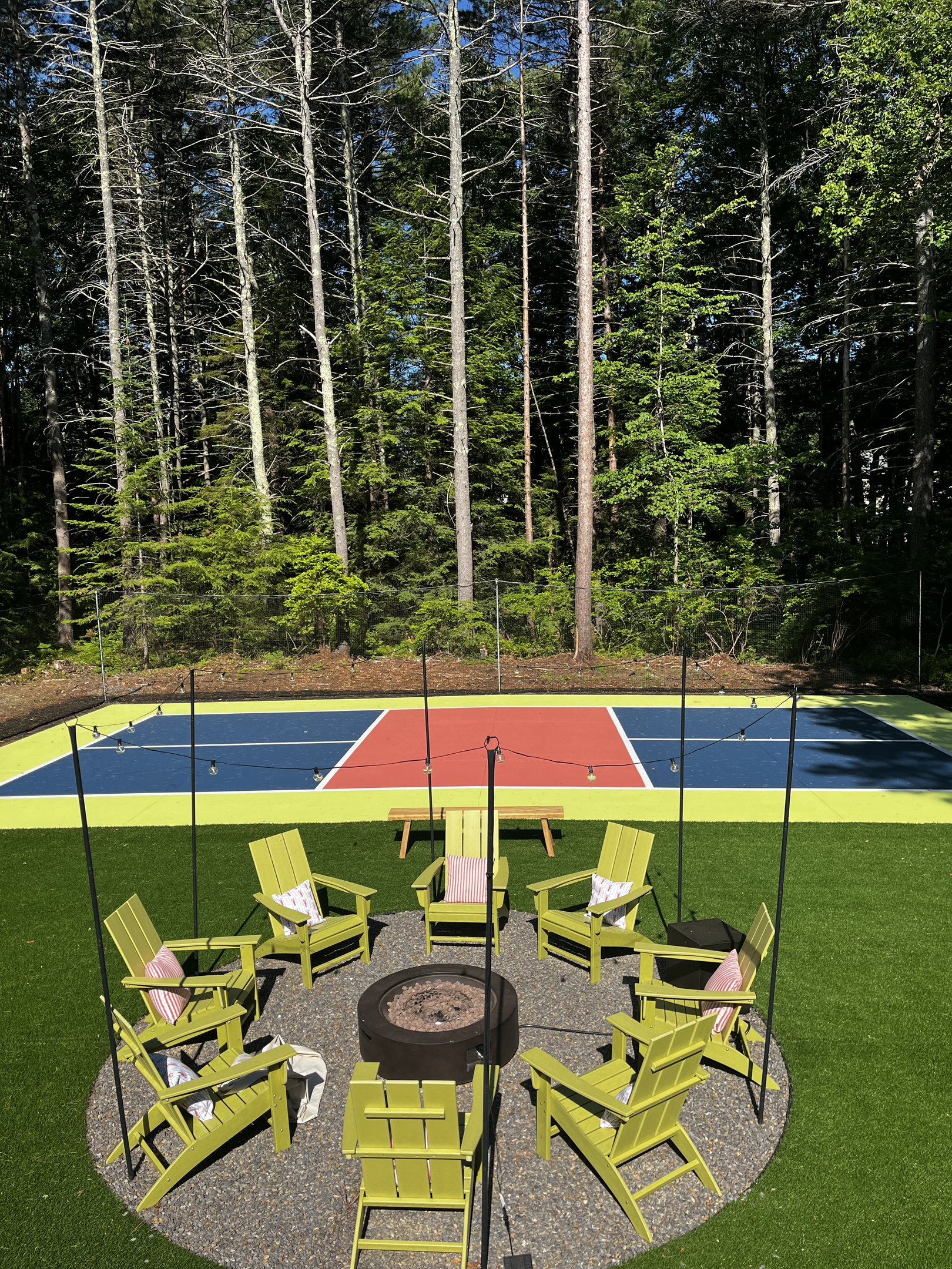 Our pickleball court and firepit, where energy meets warmth, and good times come together!