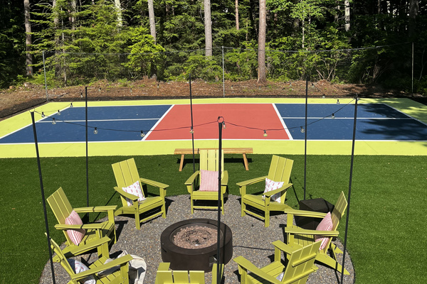 Our pickleball court and firepit, where energy meets warmth, and good times come together!
