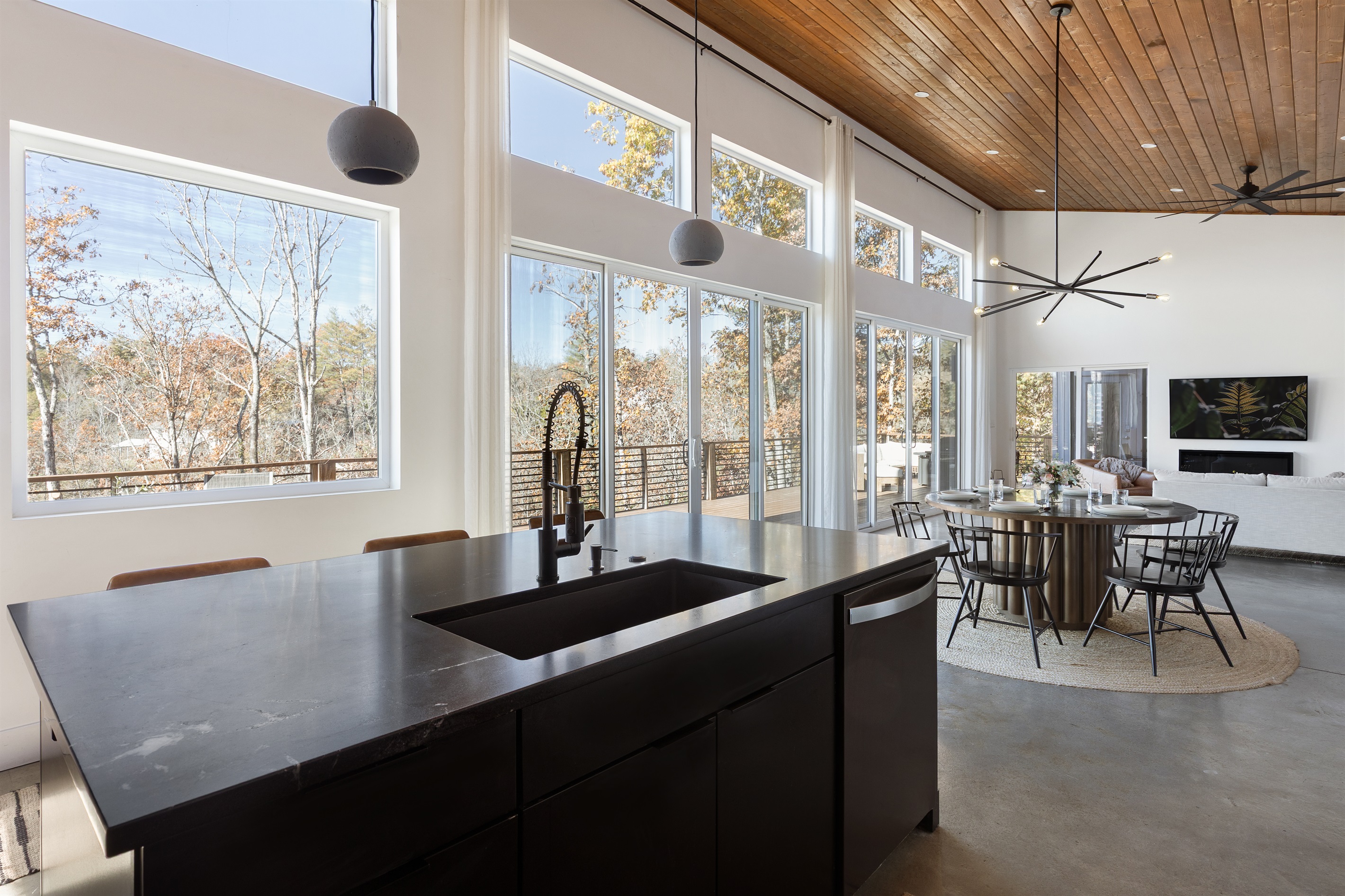 {Kitchen - Glass House} Floor-to-ceiling windows wrap the kitchen in natural light and forest views—an entertainer’s dream.
