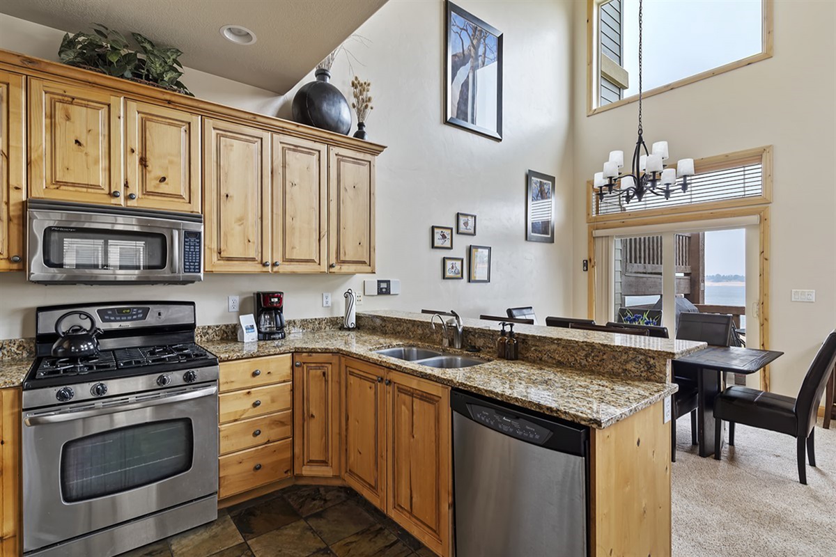 Beautifully appointed kitchen with granite countertops, stainless appliances, and custom wood cabinetry—perfect for gathering and entertaining.