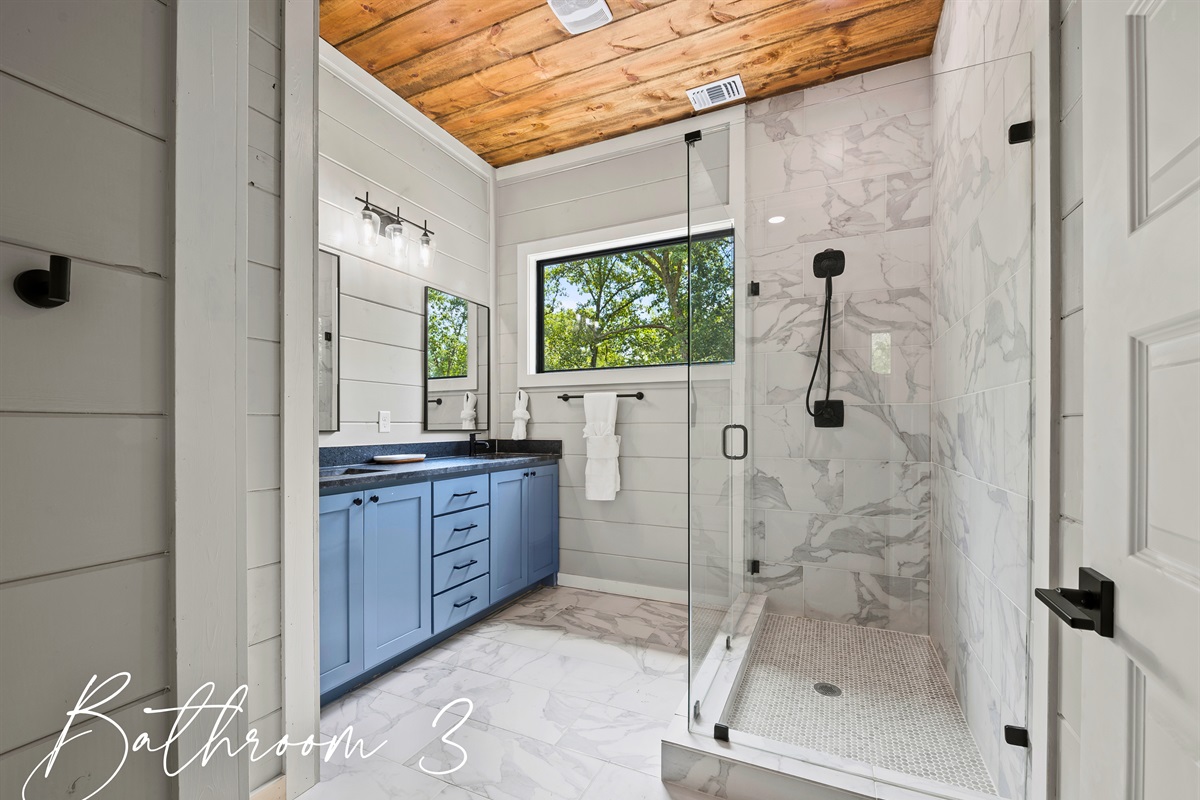Freshen up in Bathroom 3’s sleek and stylish space, with a roomy shower and double vanity to start your day on a bright note.