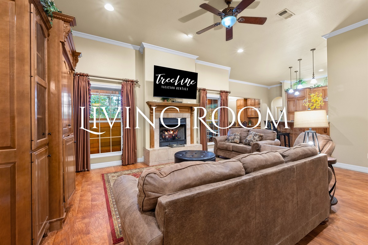 Living room with vaulted ceilings and large windows.