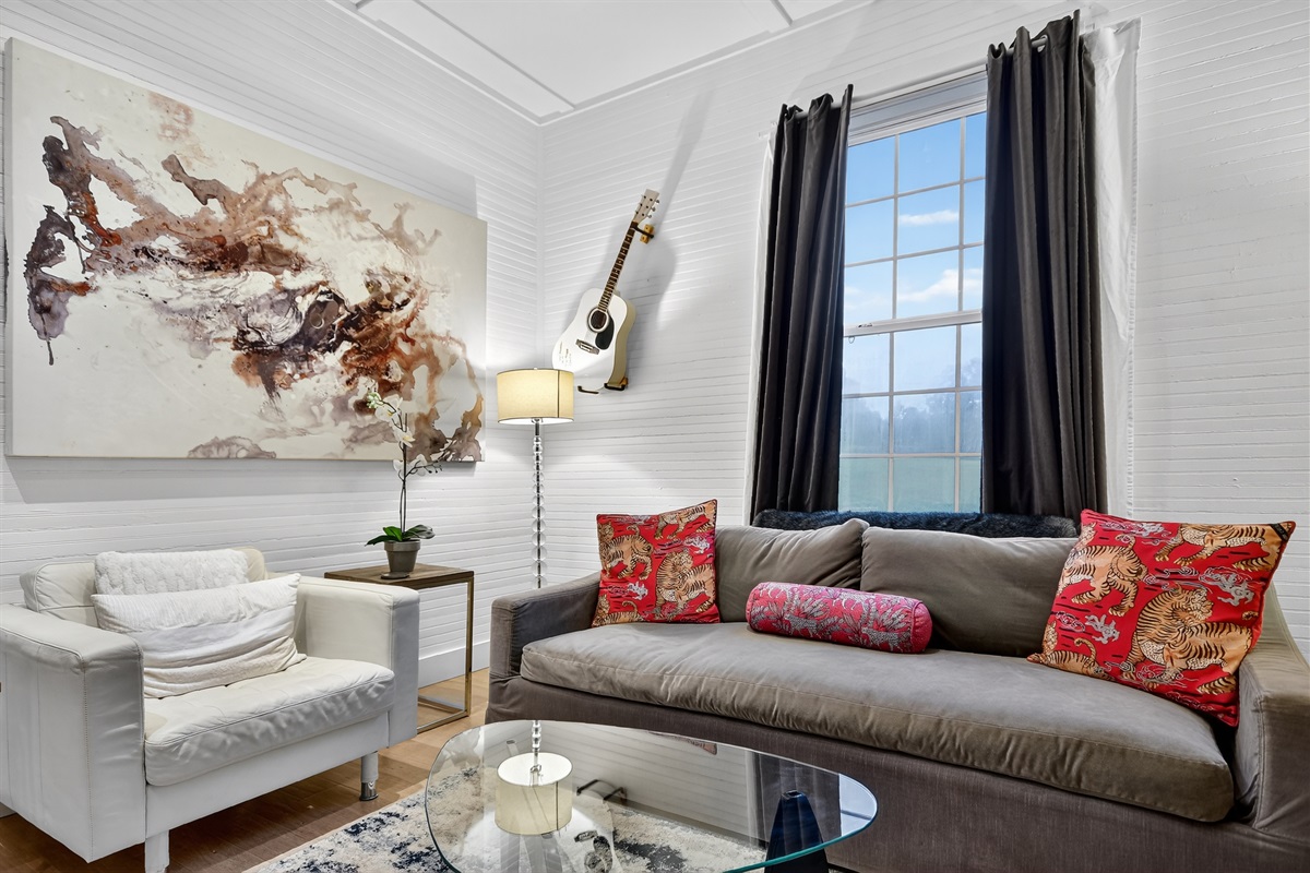 A cozy corner to relax, sip wine, or unwind with a good book. Bright, artistic, and full of character&mdash;this living room is the perfect retreat after a day in downtown Blue Ridge.