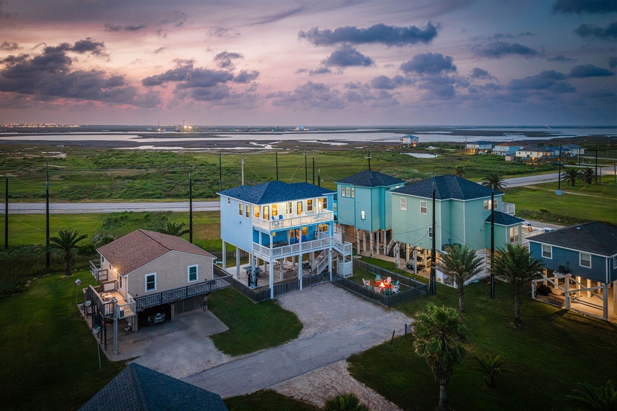 Alt sunset view — the whole exterior glowing against the Gulf sky. This is what every evening looks like.