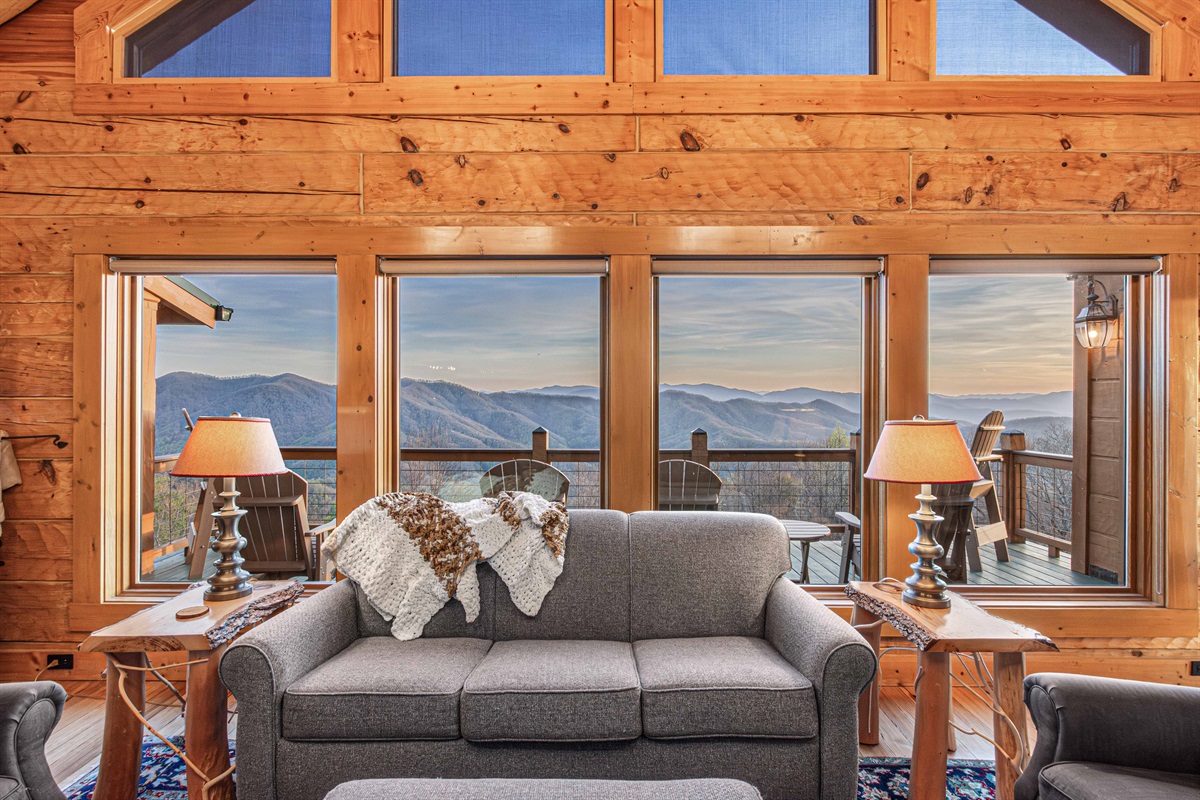 Living Room: Unwind by the fireplace with stunning mountain views and elegant wooden accents!