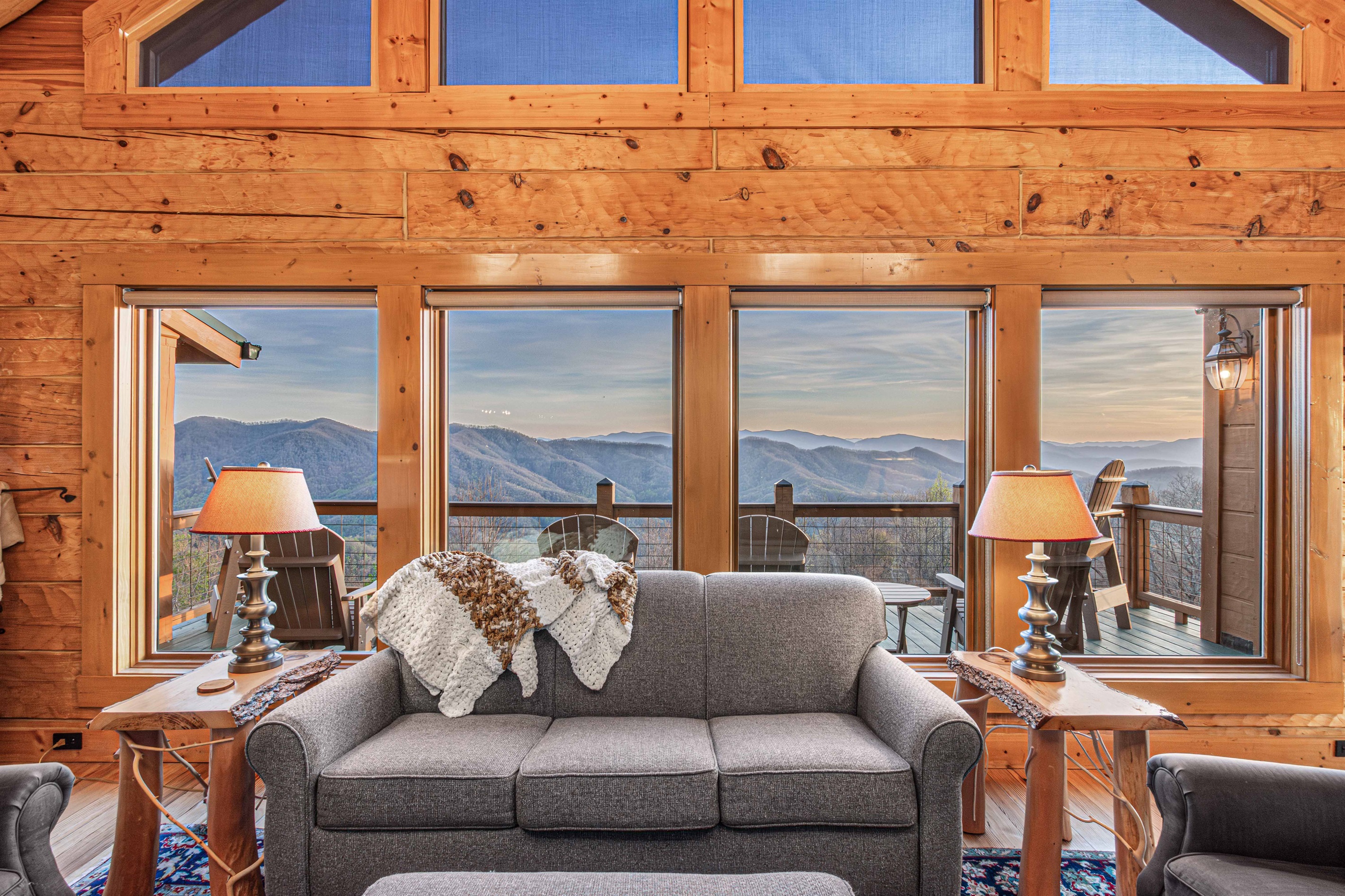 Living Room: Unwind by the fireplace with stunning mountain views and elegant wooden accents!