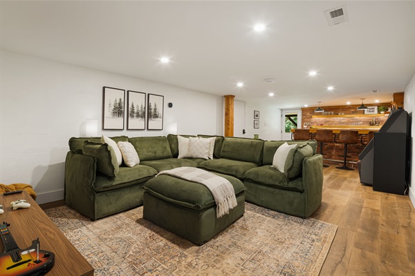 A nice open floorplan of the basement offers lounging and entertaining options with a super cool, restored, vintage jukebox and a speakeasy bar setting with all the equipment needed for entertaining. 