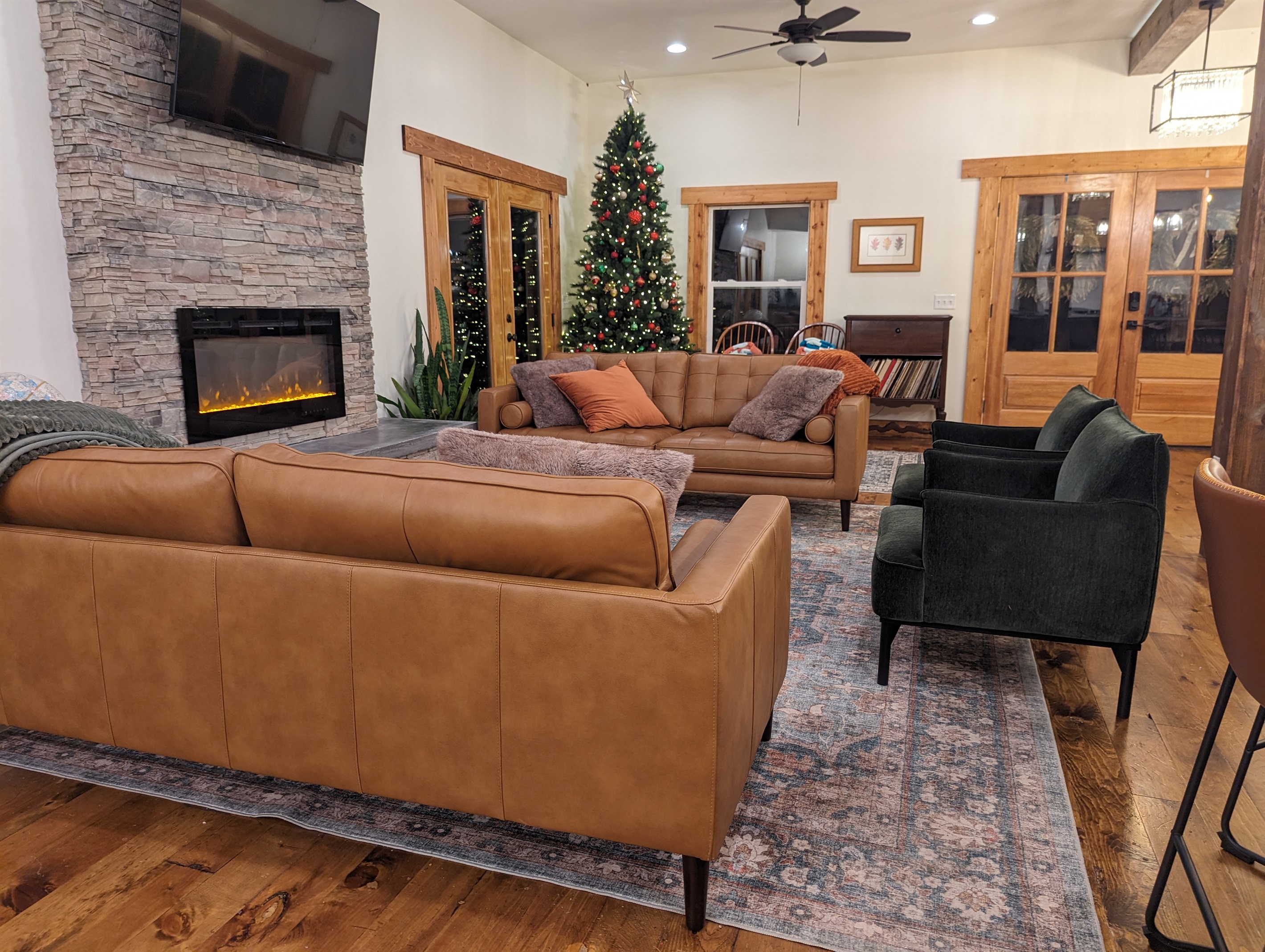 The heart of the lodge. Relax by the stone fireplace and take in the stunning forest views through wall-to-wall windows. Perfect for morning coffee or evening storytelling