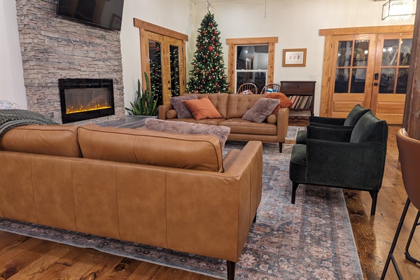 The heart of the lodge. Relax by the stone fireplace and take in the stunning forest views through wall-to-wall windows. Perfect for morning coffee or evening storytelling