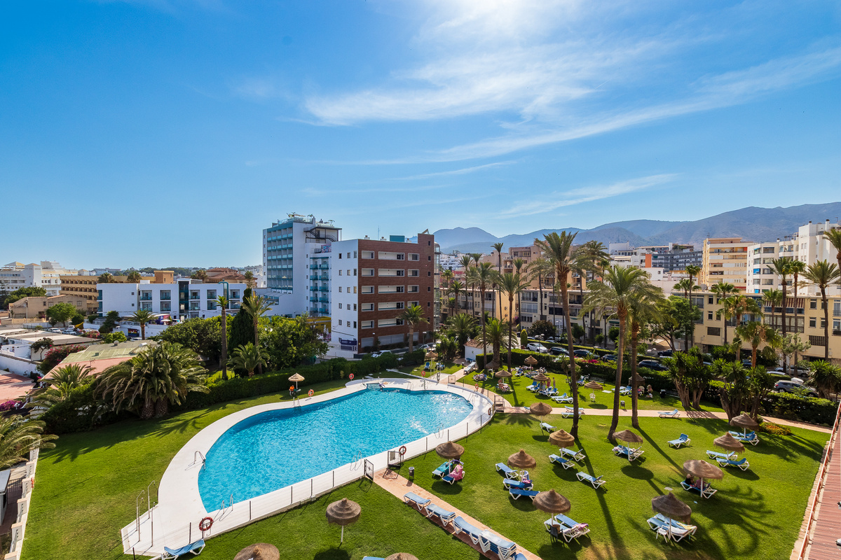Shared pool and landscaped grounds with city and mountain views.