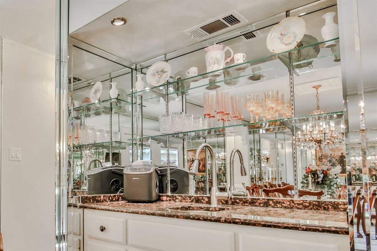 Seats for eight and a wet bar ready to pour—perfect for feasting, clinking glasses, and spilling all the tea.