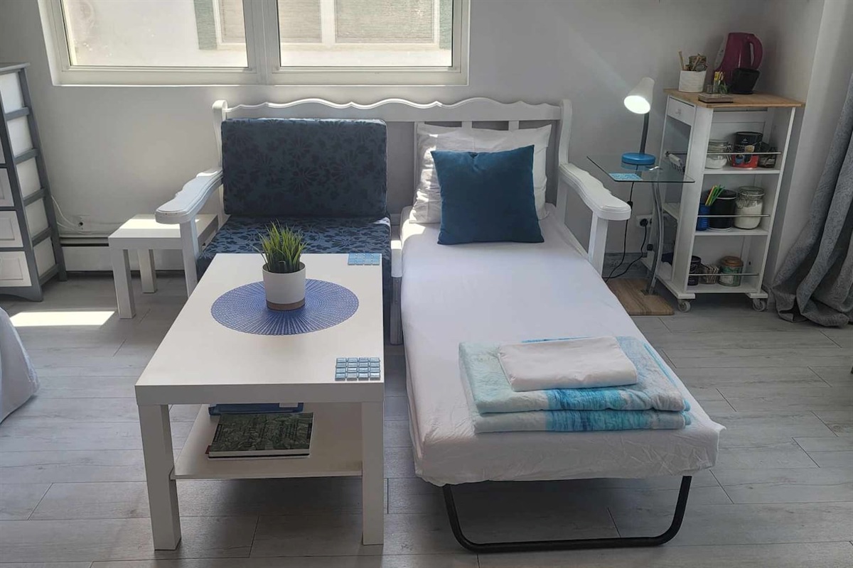 Sofa bed made up for one guest, this can be made into 2 single beds