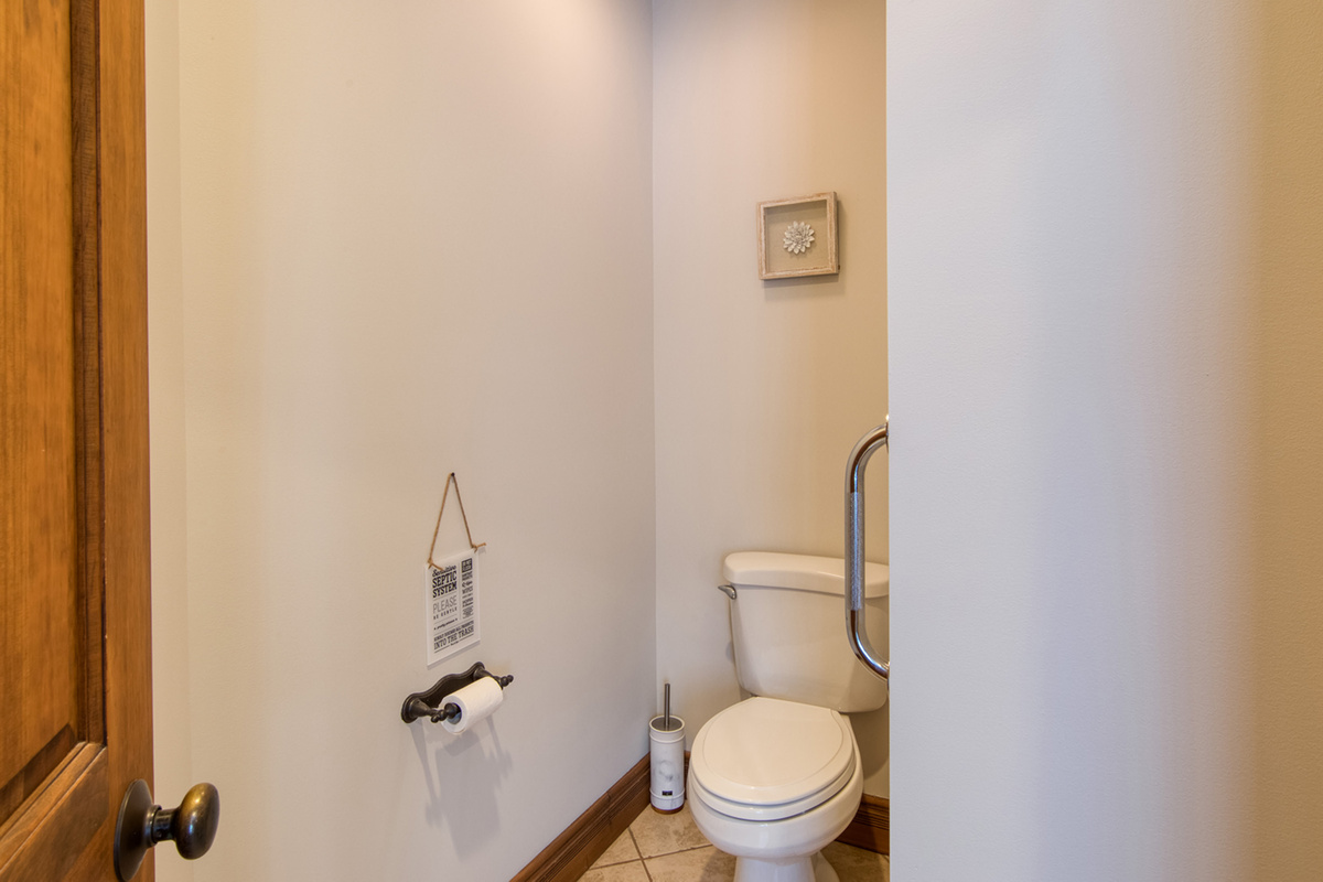 Separate water closet provides added convenience within the primary suite.