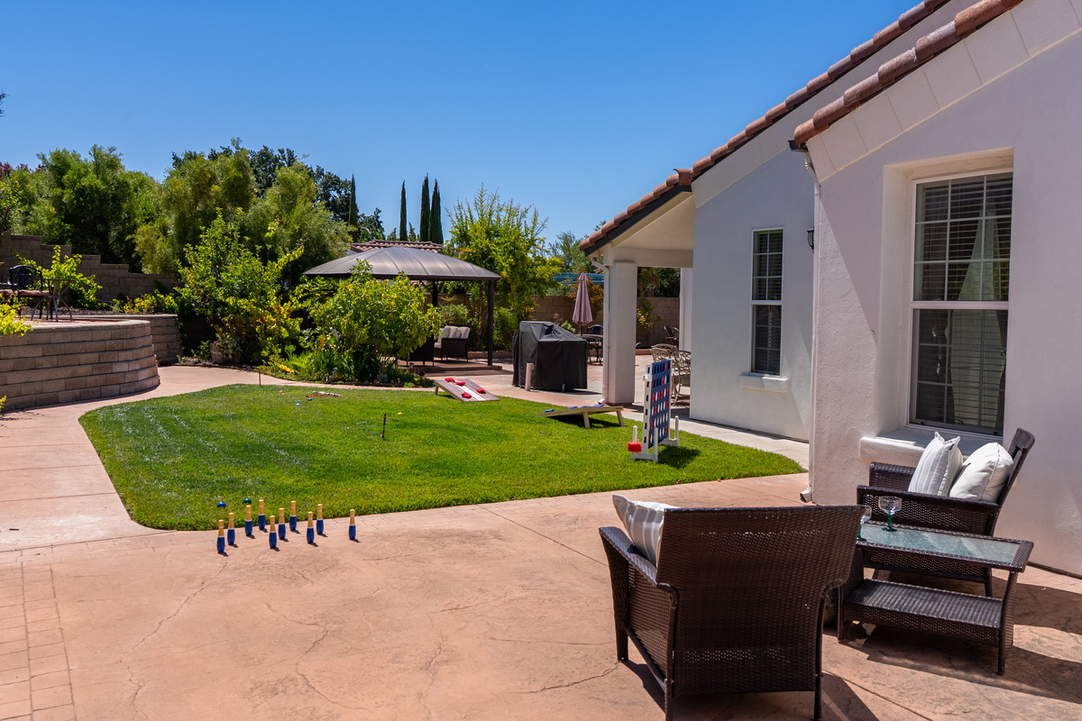 Enjoy a collection of lawn games in the backyard.