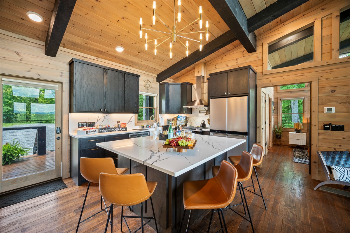 This sleek, modern kitchen with a large island is ideal for hosting and enjoying time with family and friends.