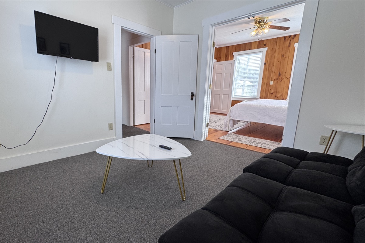 The study lounge off of the Primary Bedroom with a futon couch and TV