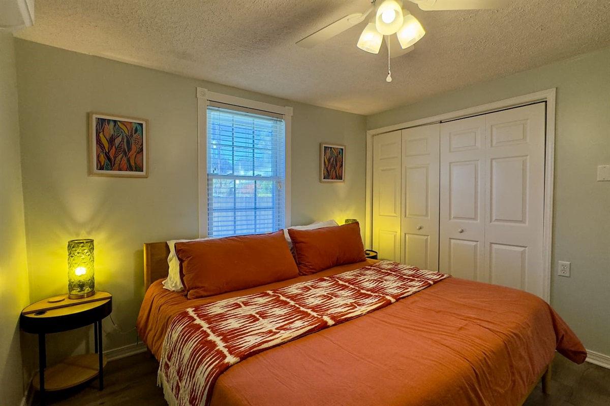 Warm, inviting bedroom with a comfortable bed, soft ambient lighting, and ample closet space.