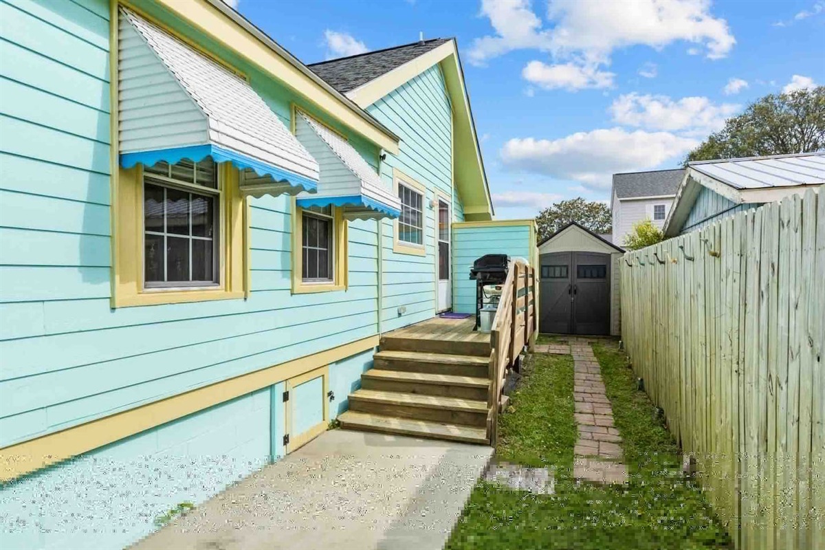 Backyard walk way to the private outdoor shower and amenities shed.
