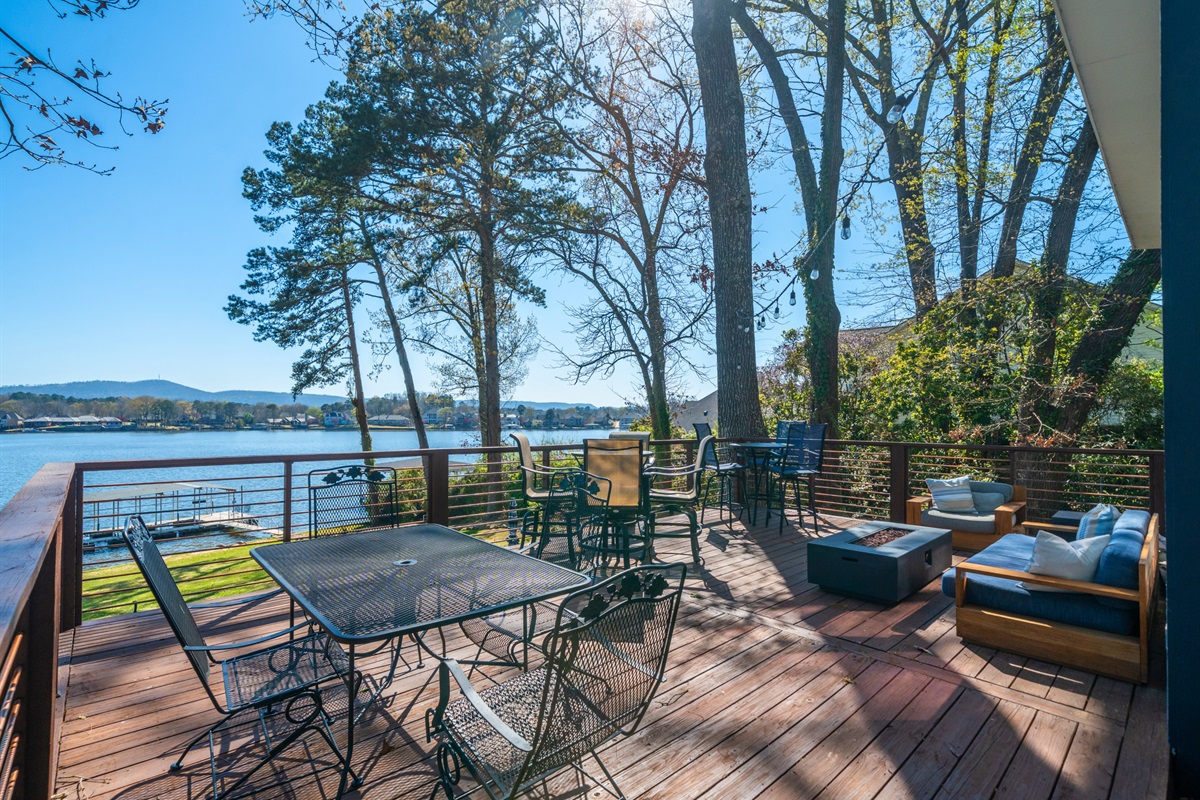 Gather around the outdoor table for drinks, games, or casual meals while enjoying the shade and surrounding nature.