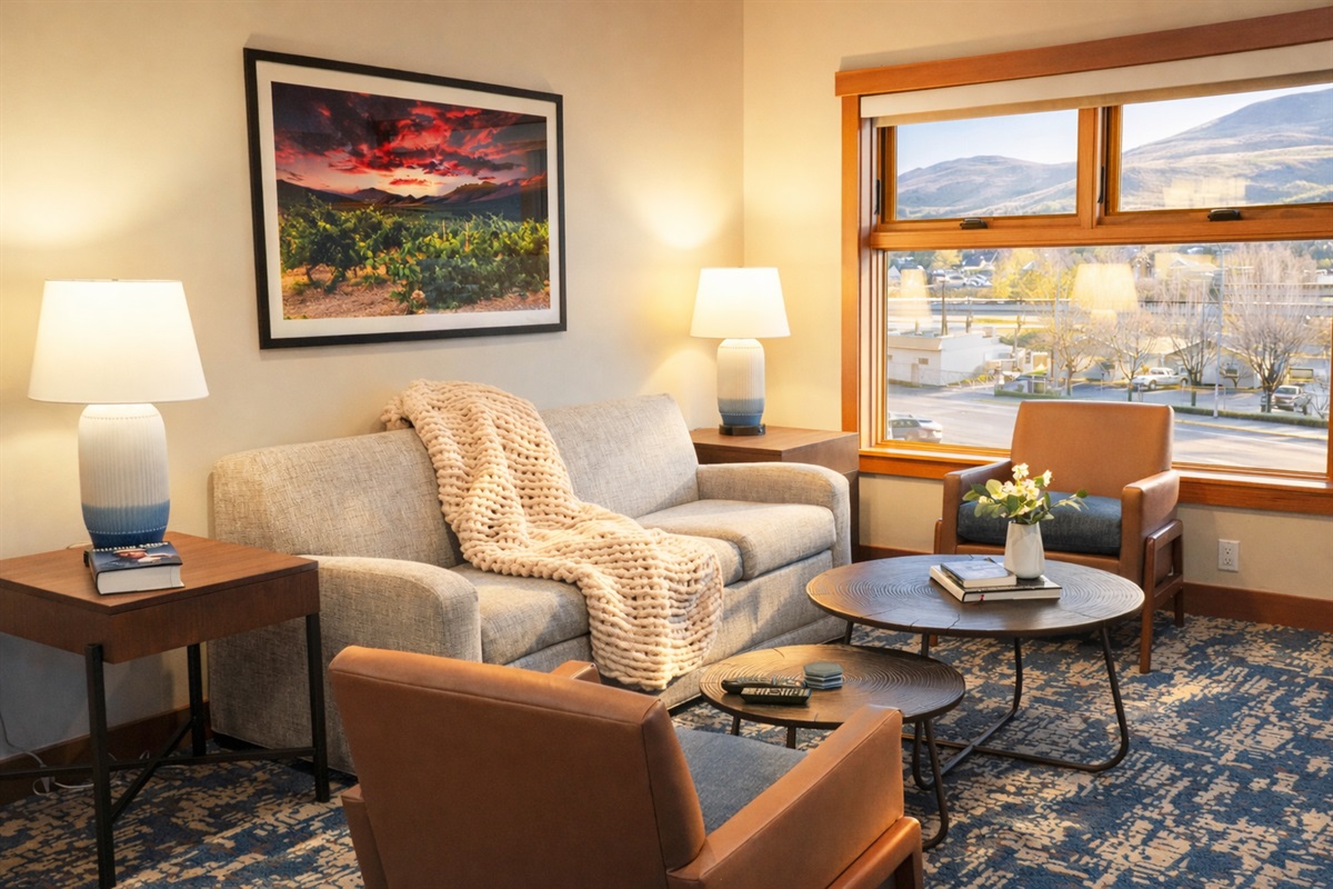 Open living room with TV, fireplace, lake view and with pull-out couch