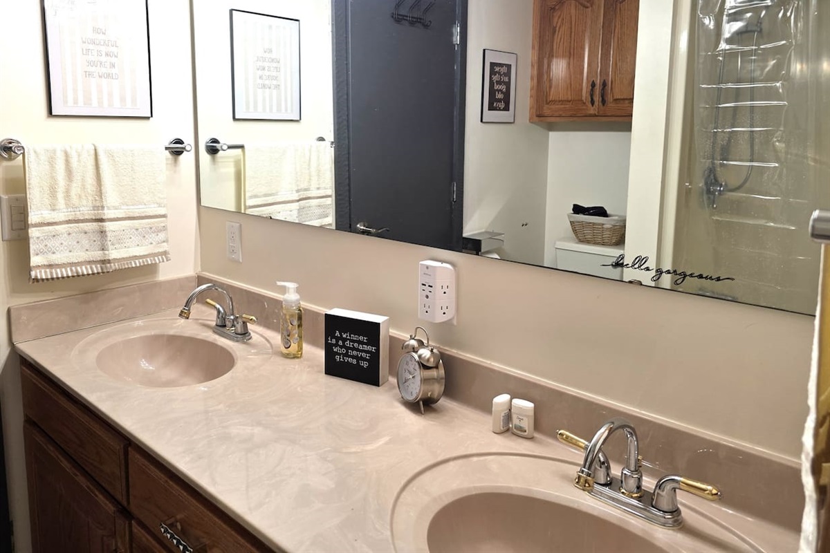 Downstairs bathroom with tub/shower, double sinks and toilet