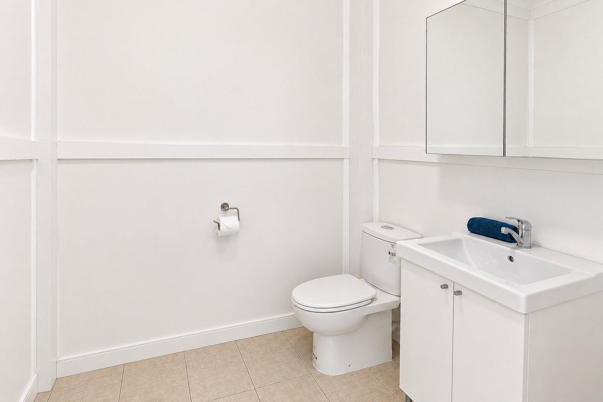An extra half bathroom at Carlenes Getaway adds convenience, with a toilet and vanity separate from the main bathroom.
