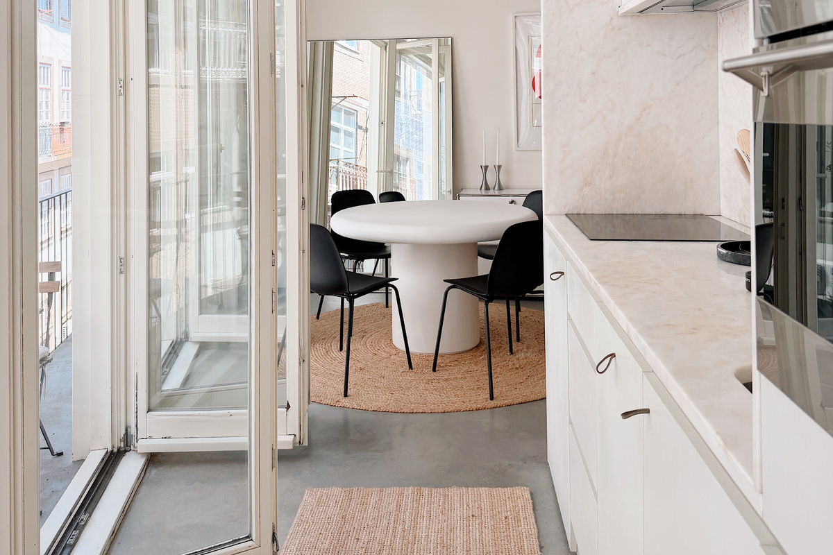 Kitchen and dining area with balcony doors open.
