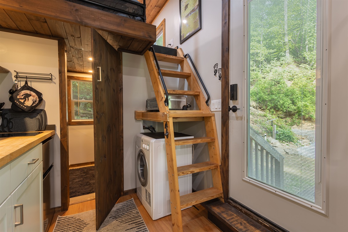 Smart tiny home design includes loft access, an all-in-one washer/dryer, and thoughtful use of every space.