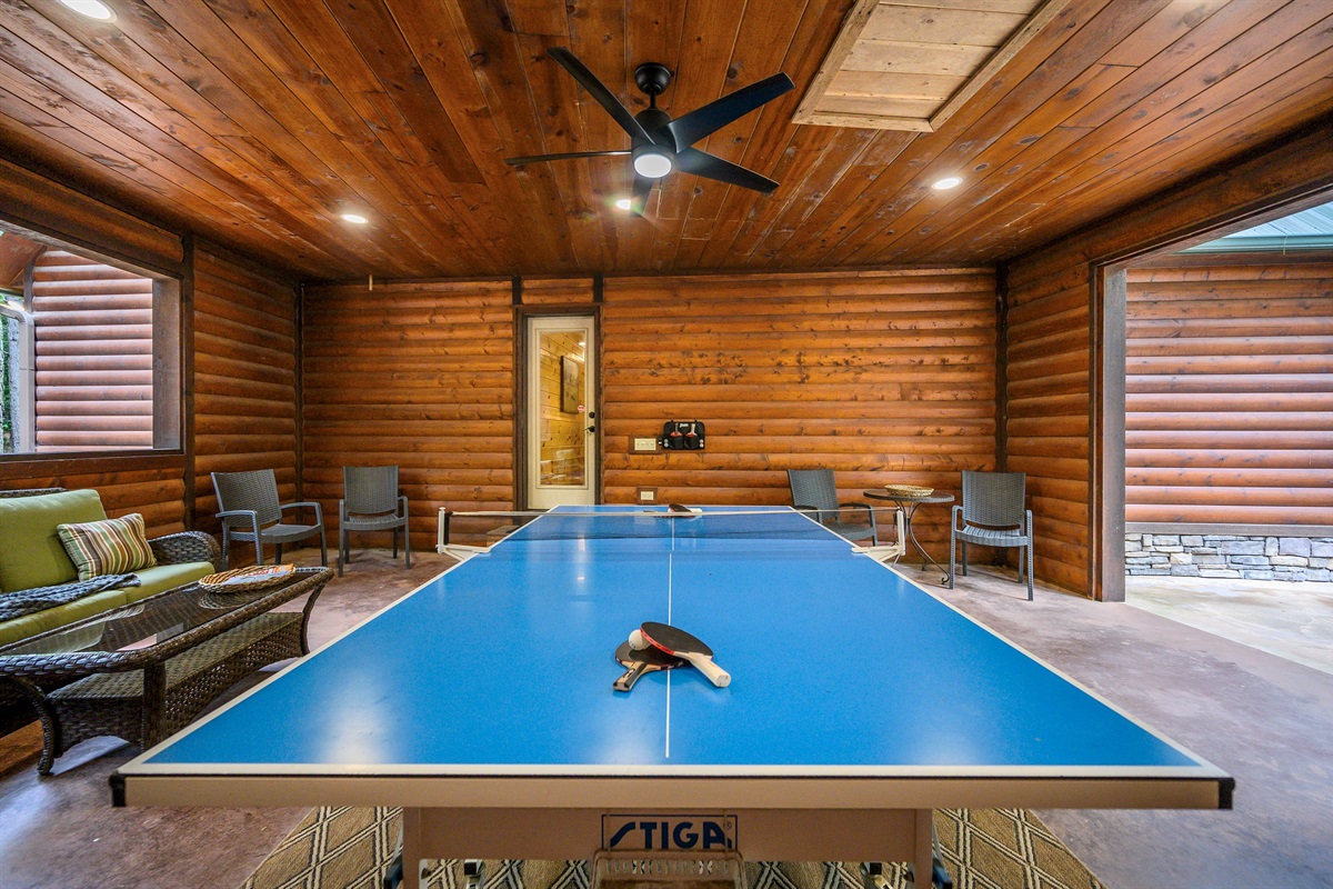Breezeway off the main living provides seating and full size ping pong table.