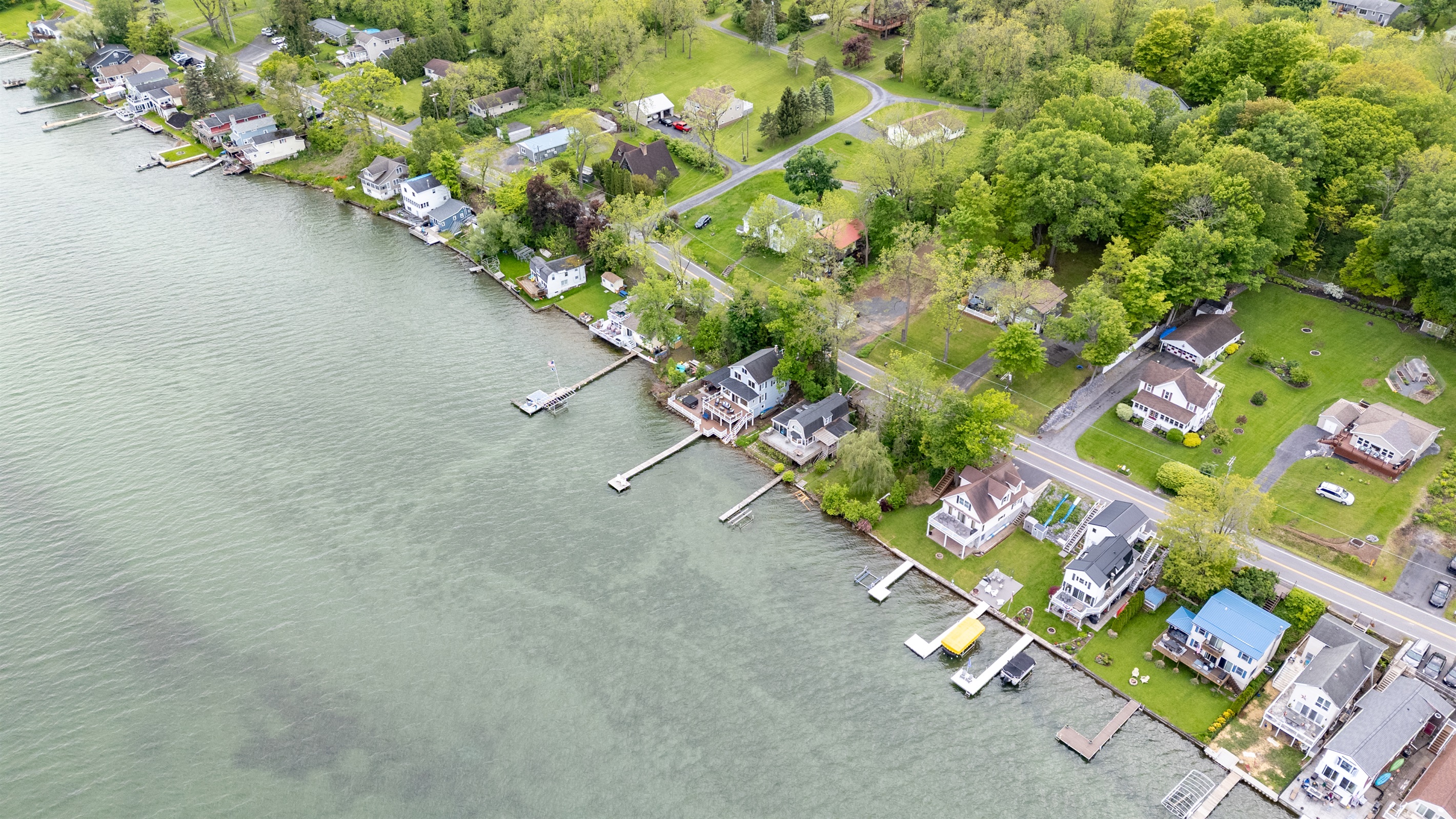 Aerial shot showcasing expansive lakefront entertaining space, hot tub, and private dock for the ultimate getaway 🎯🌊🍹