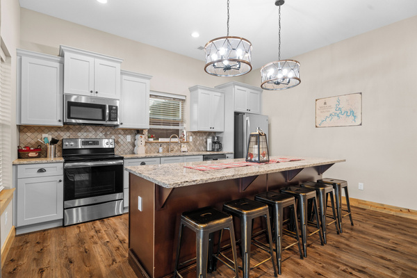 Lower level FULL kitchen. Refrigerator, dishwasher, oven/ceramic glass cooktop, microwave, drip coffee maker, Keurig, and Nespresso. Stocked with small appliances, cookware, bakeware, utensils, dishes, glassware, mugs, and more!