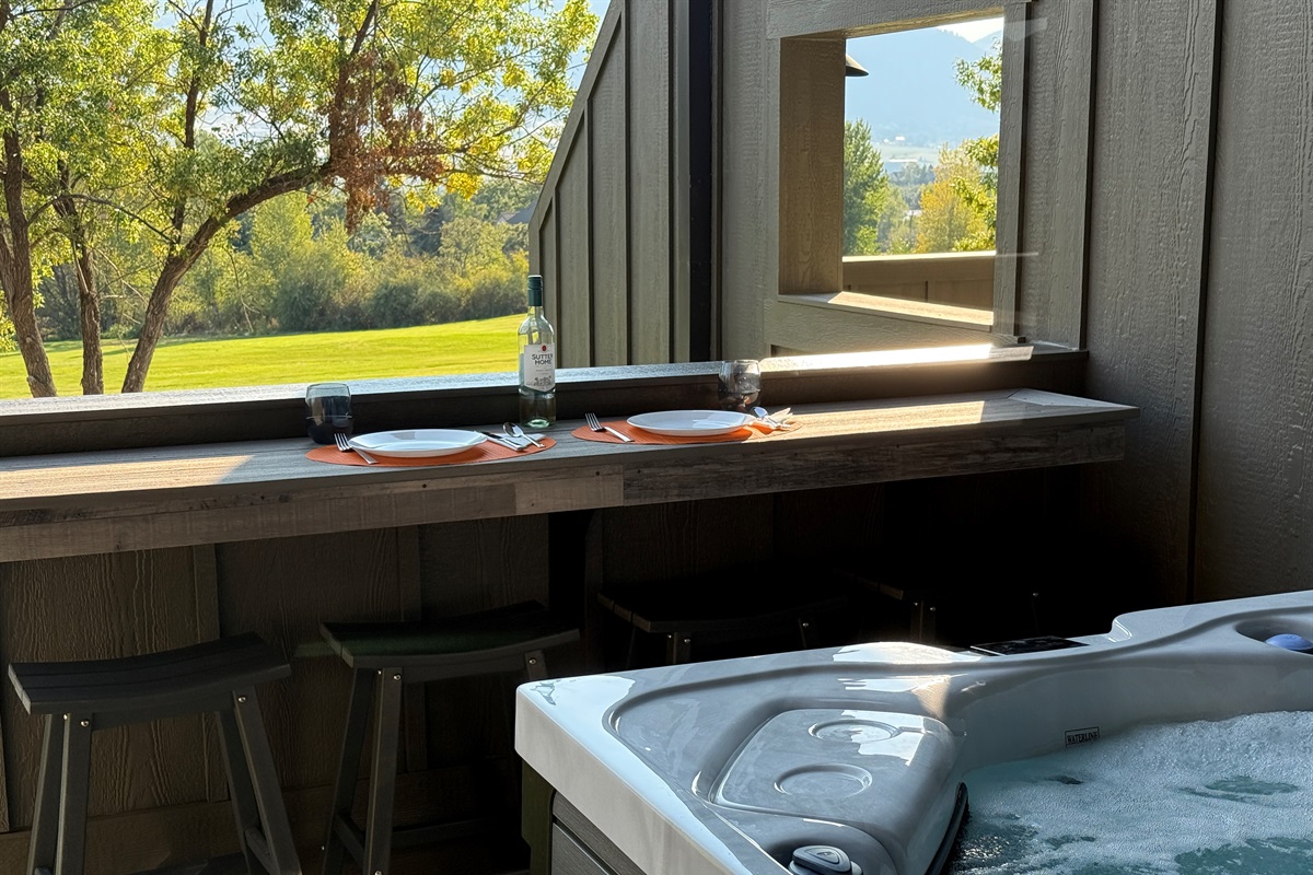 Enjoy meals outside on the bar top table near the private hot tub.