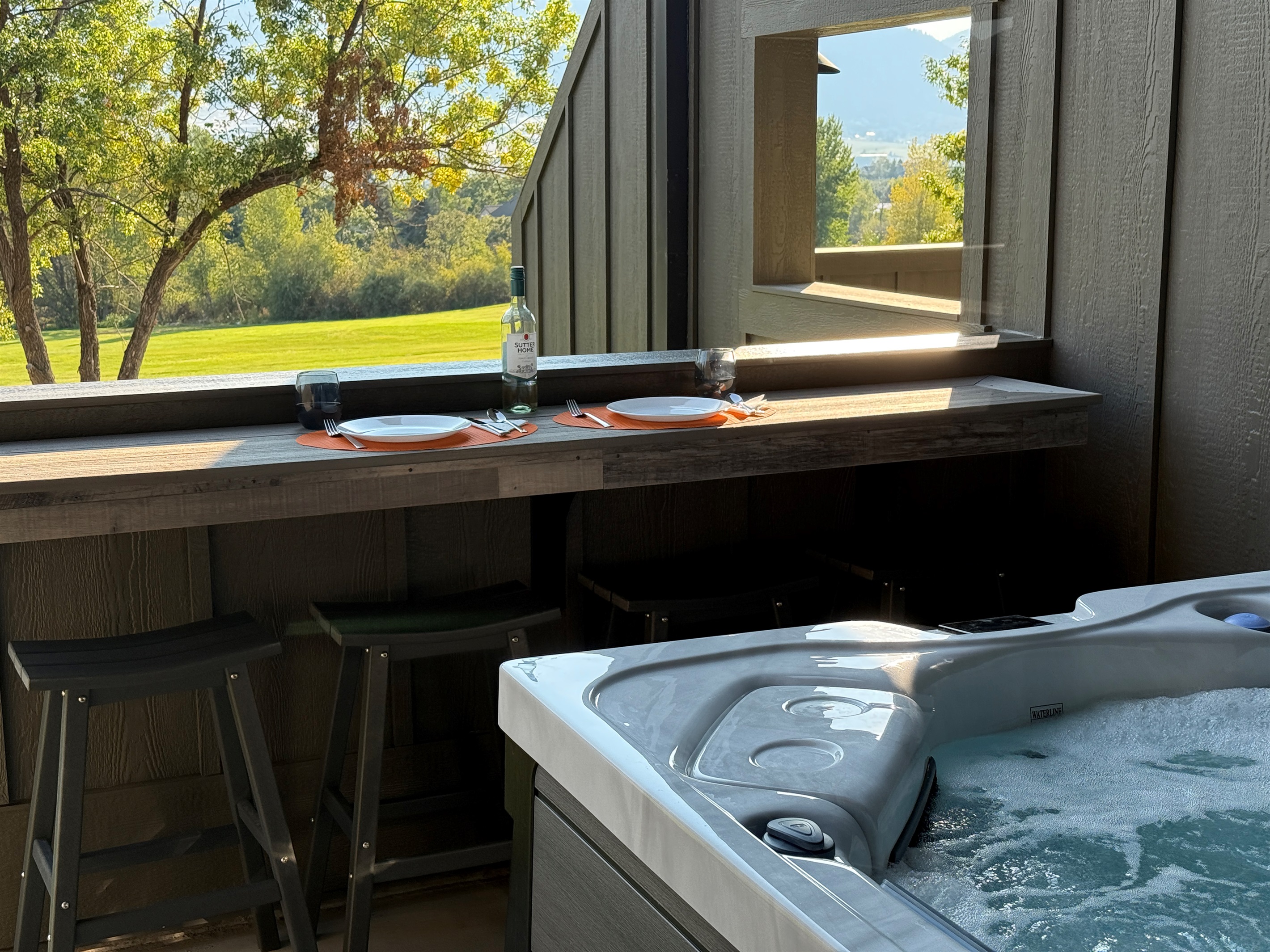 Enjoy meals outside on the bar top table near the private hot tub.
