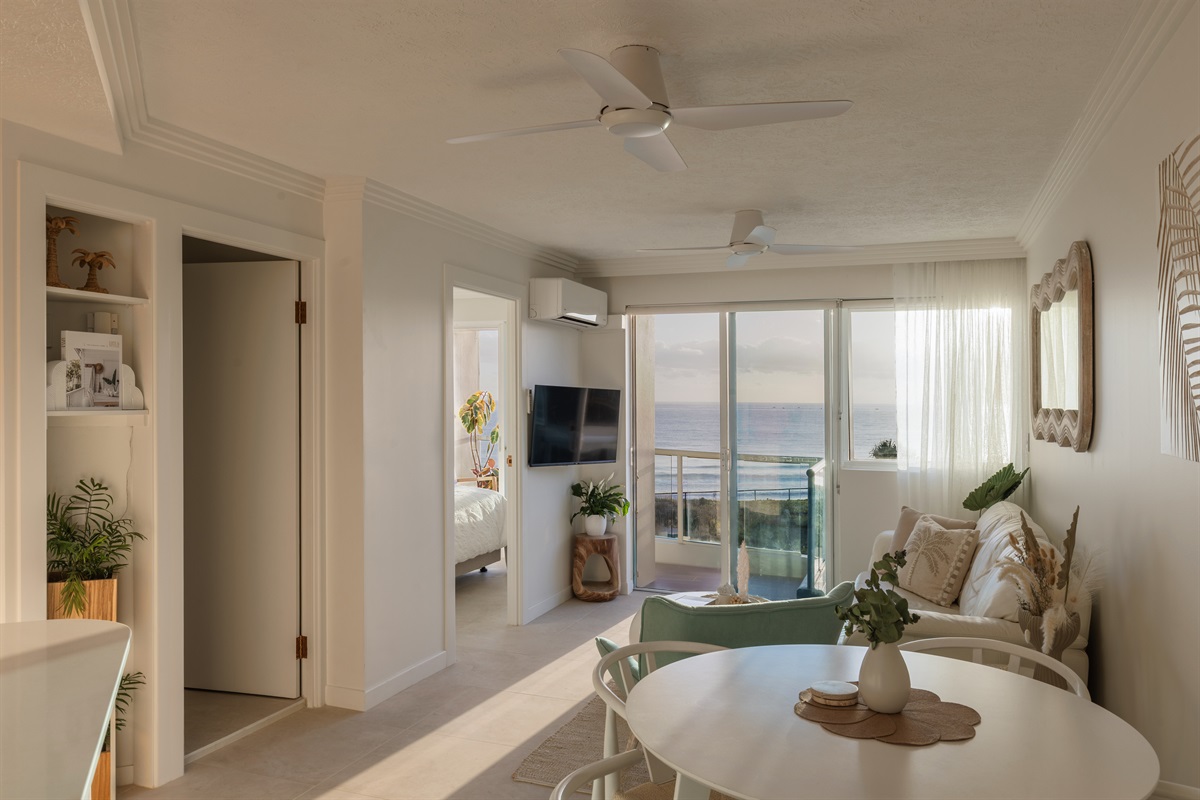 Spacious coastal living with seamless flow to ocean-view balcony.