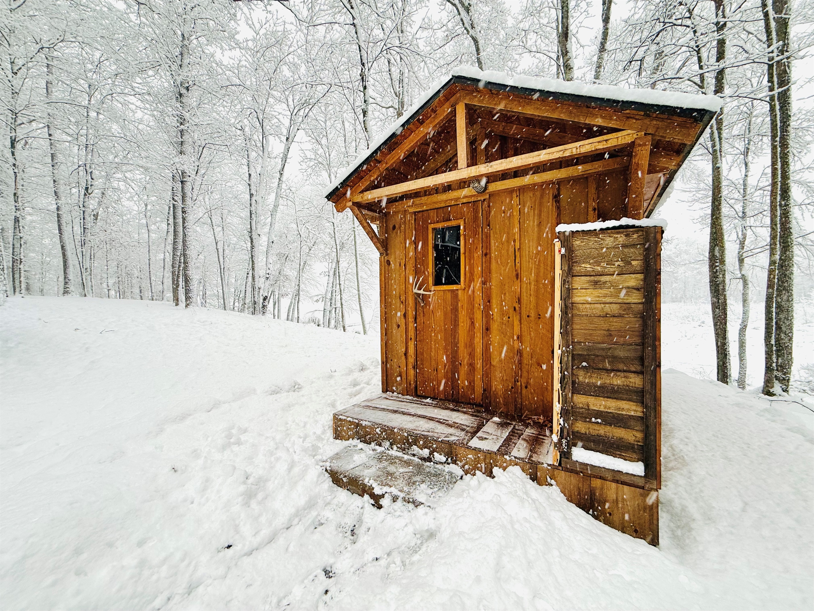 Our authentic wood burning sauna with a great view of the lake.