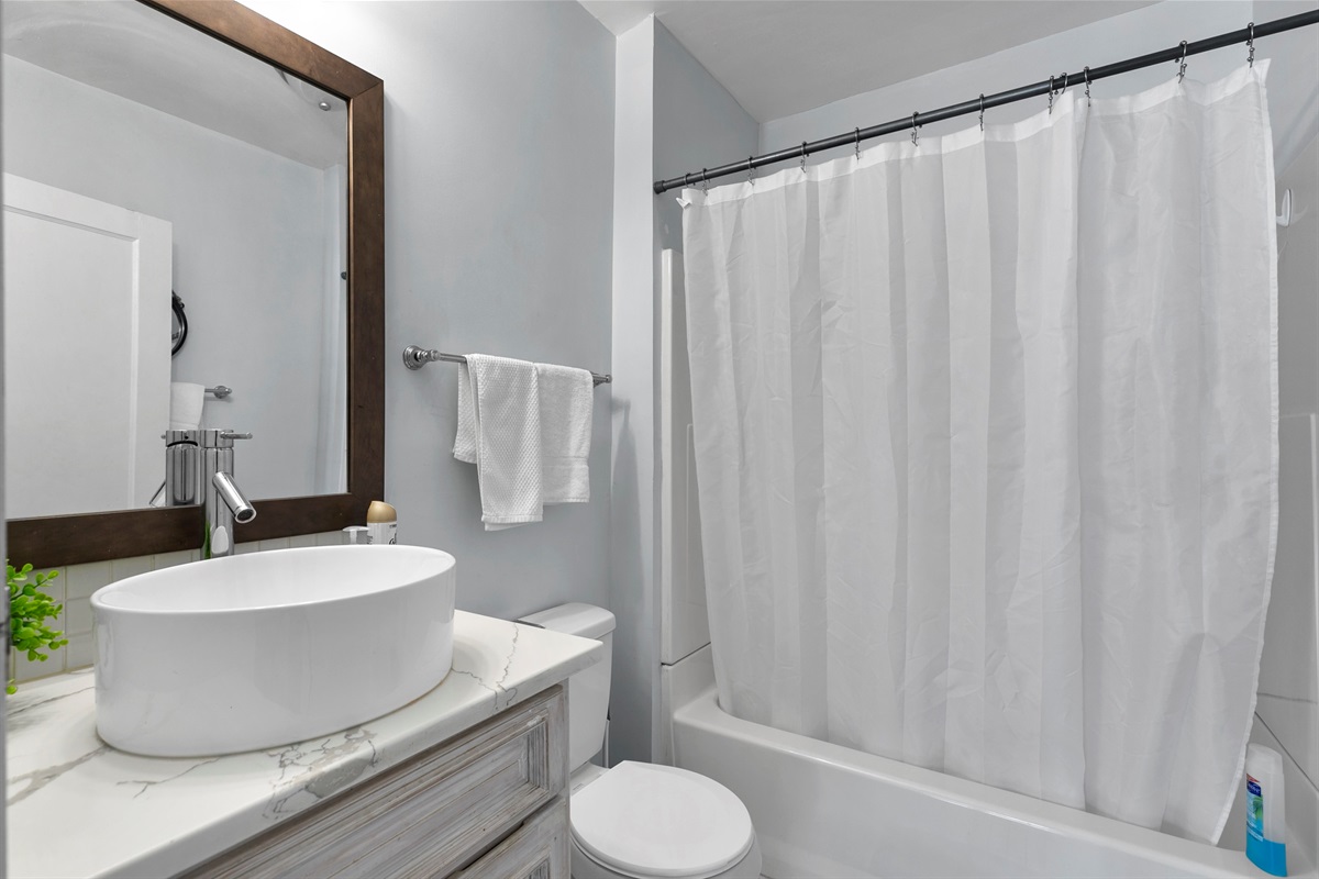 Enjoy a full bathroom with an artisan style sink and a convenient tub/shower combo