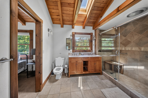Primary bathroom with doors to the loft and primary bedroom. 