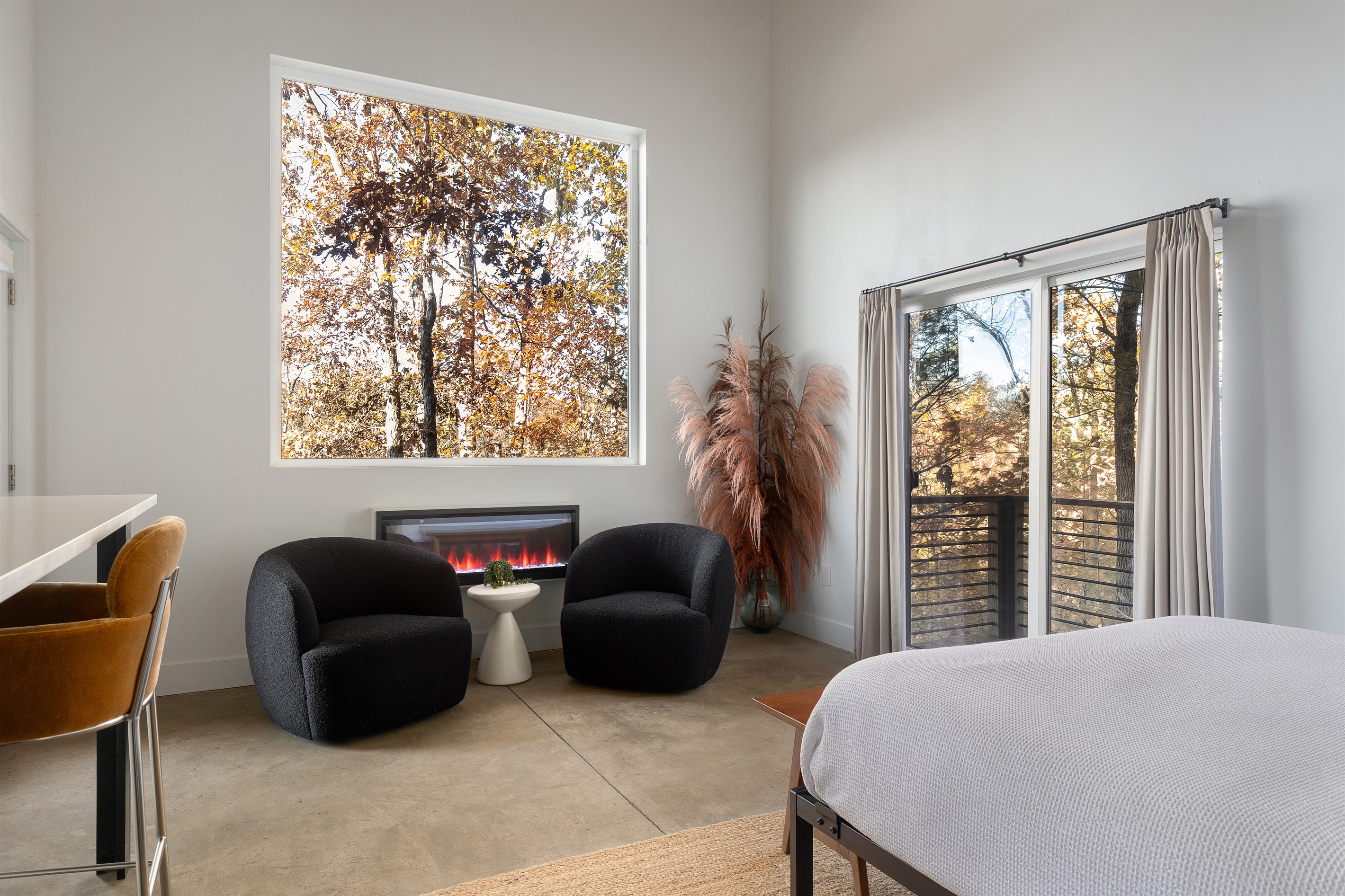 {Casita Lounge} Cozy lounge seating, electric fireplace, and treetop views—your personal retreat within the retreat