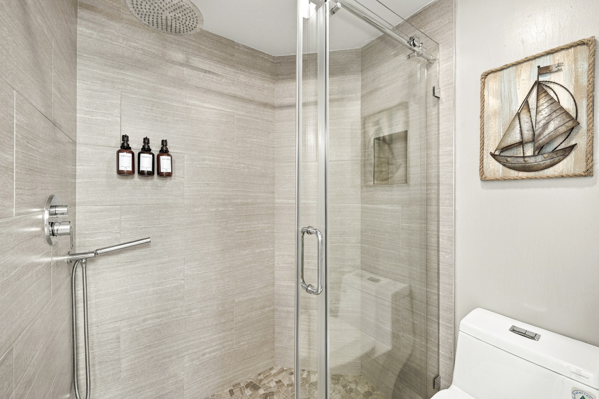 Master walk-in shower has a rain shower head and shower wand.
