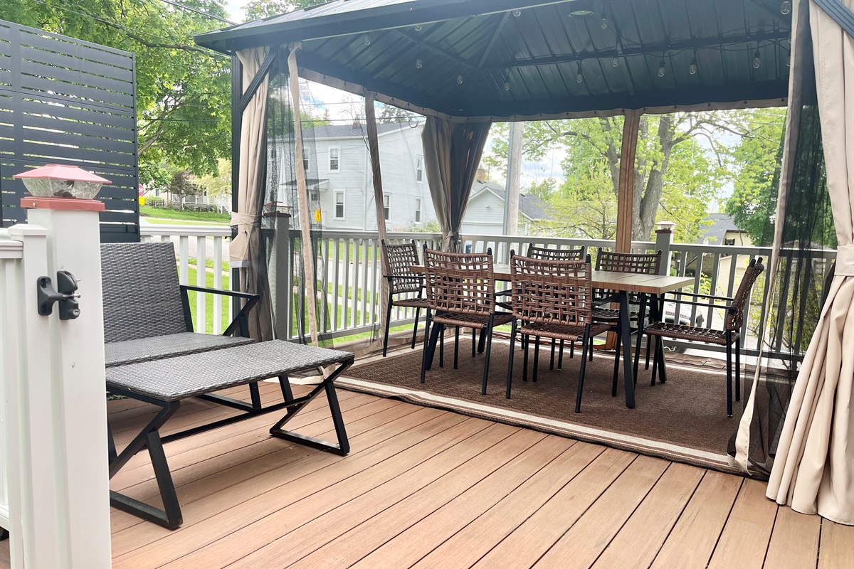 Beautiful pergola-covered deck with dining and seating area.