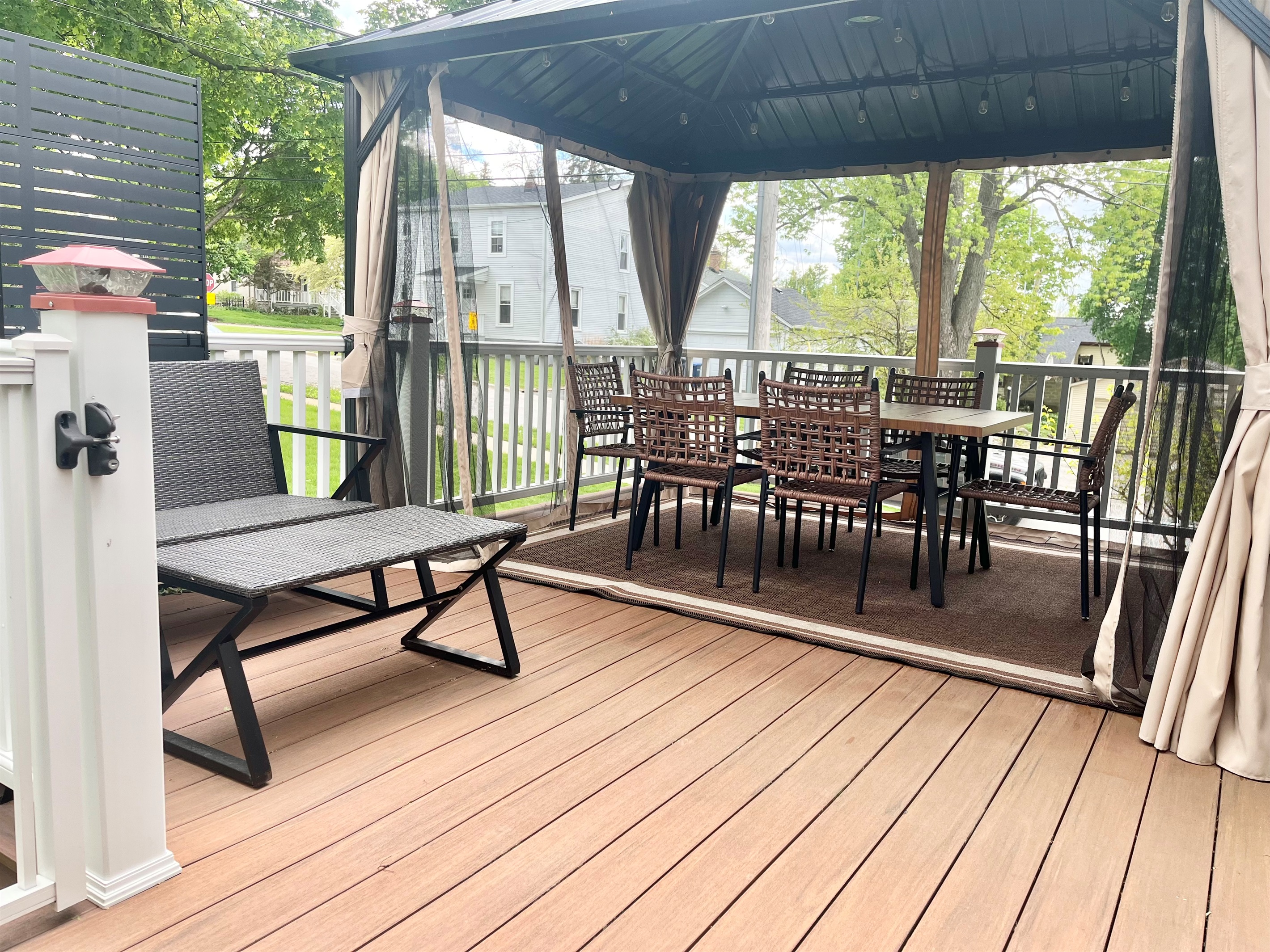 Beautiful pergola-covered deck with dining and seating area.