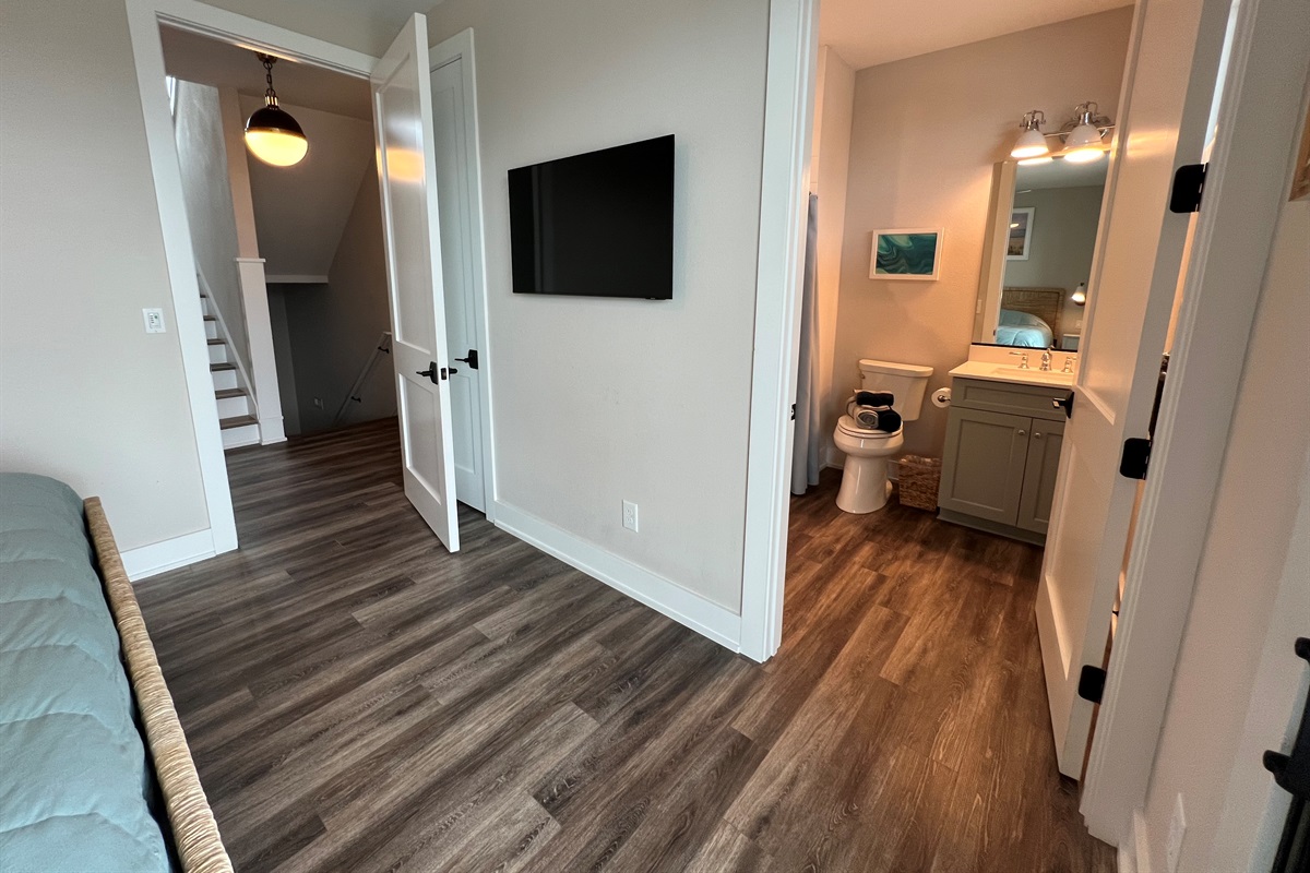 Wheelchair accessible king bedroom ensuite. West King bedroom with ensuite and door to deck with hot tub.