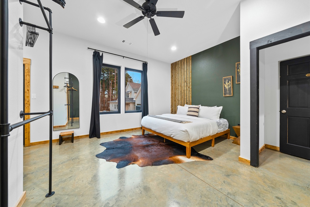 The spacious layout and large windows make this bedroom feel airy, bright, and easy to relax in.
