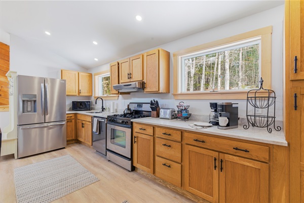 Brew your morning coffee with a view of the Maine woods; our kitchen offers the perfect sunny start to your day.