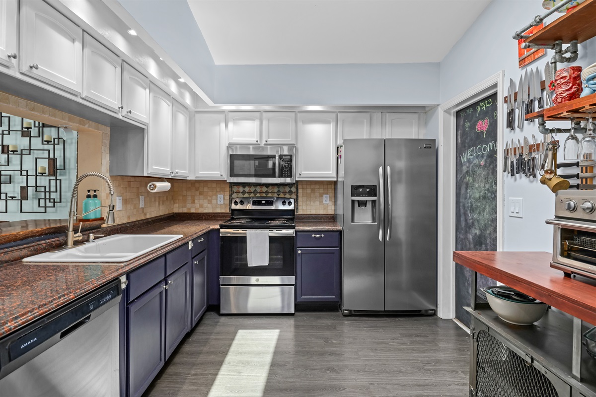 From the hallway, you can see a bright, open kitchen.
