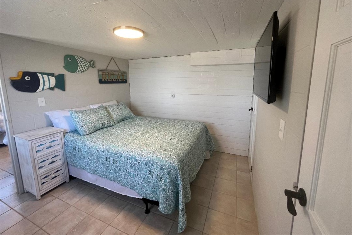 Downstairs bedroom with a queen bed