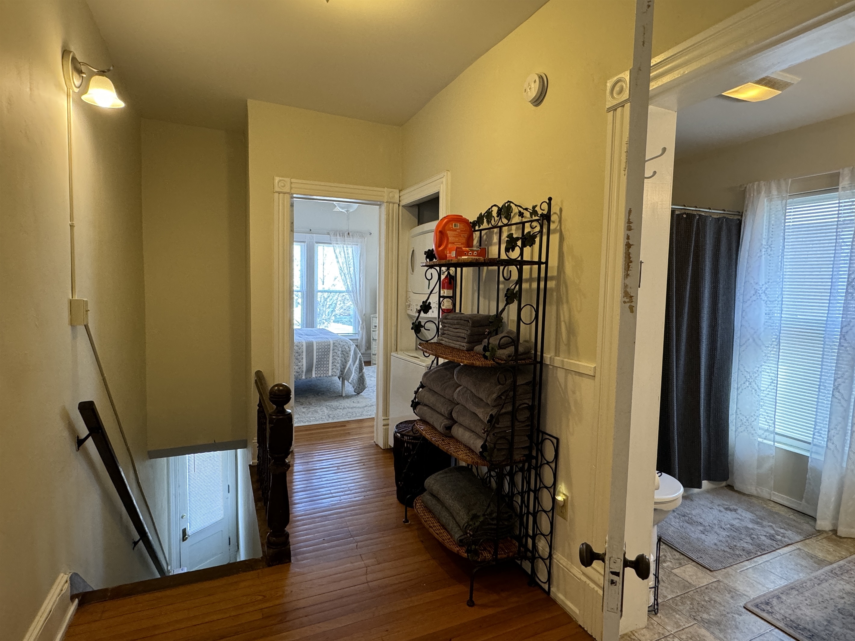 Hallway with laundry and stairs to entrance